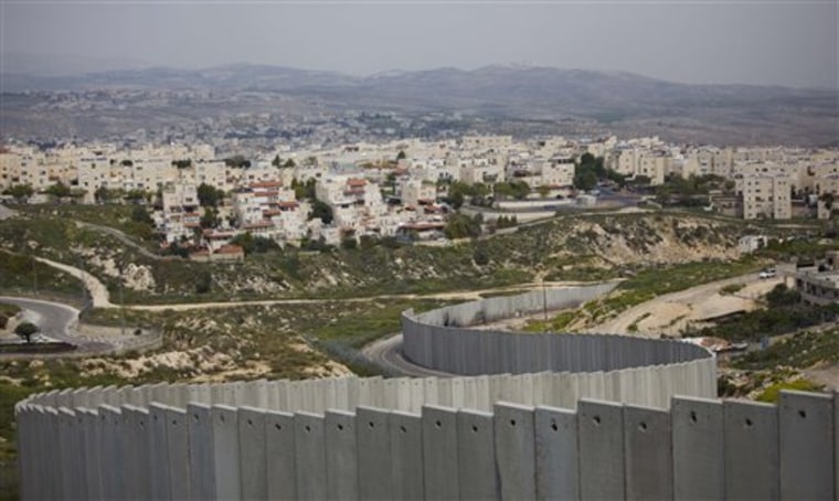 The Jewish neighborhood of Pisgat Zeev in east Jerusalem is seen behind a section of Israel's separation barrier. Two Palestinian officials say Israel is proposing to essentially turn its West Bank barrier into the border with a future state of Palestine.=